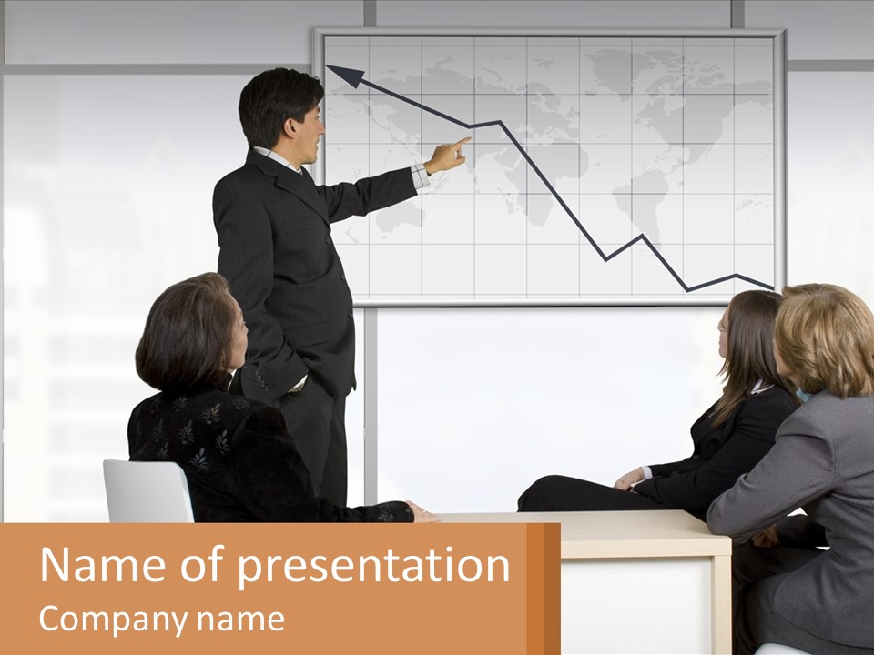 A Group Of People Sitting Around A Table In Front Of A Whiteboard PowerPoint Template
