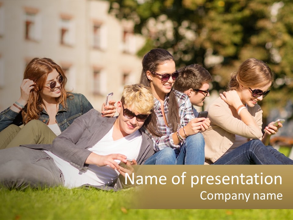 A Group Of People Sitting On The Grass Looking At Their Cell Phones PowerPoint Template