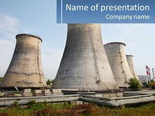 A Power Plant With Three Towers In The Background PowerPoint Template