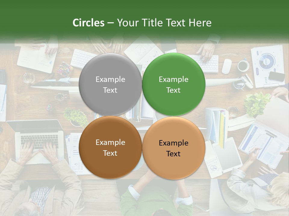 A Group Of People Sitting At A Table Working On Laptops PowerPoint Template