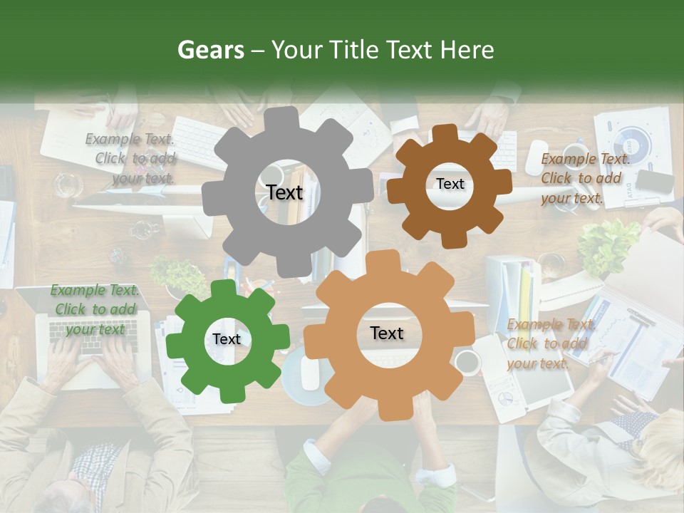 A Group Of People Sitting At A Table Working On Laptops PowerPoint Template