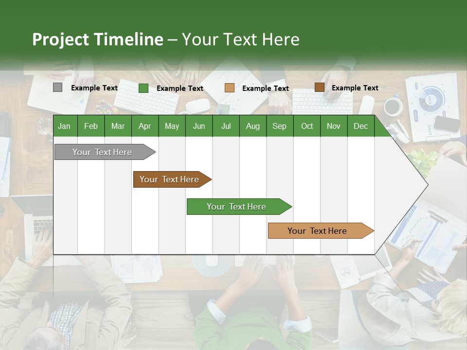 A Group Of People Sitting At A Table Working On Laptops PowerPoint Template