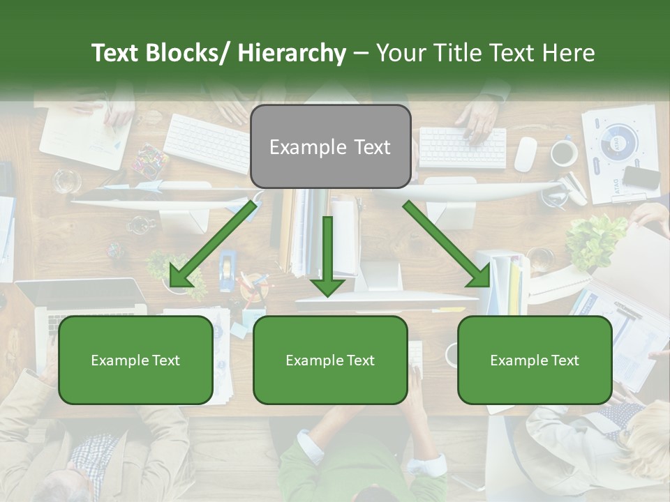A Group Of People Sitting At A Table Working On Laptops PowerPoint Template