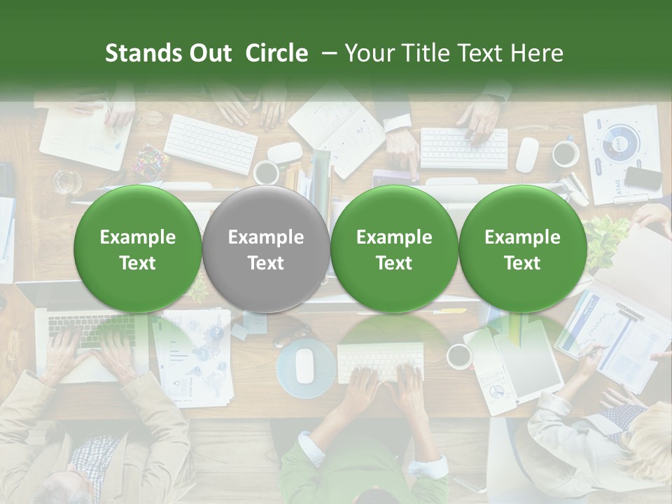 A Group Of People Sitting At A Table Working On Laptops PowerPoint Template