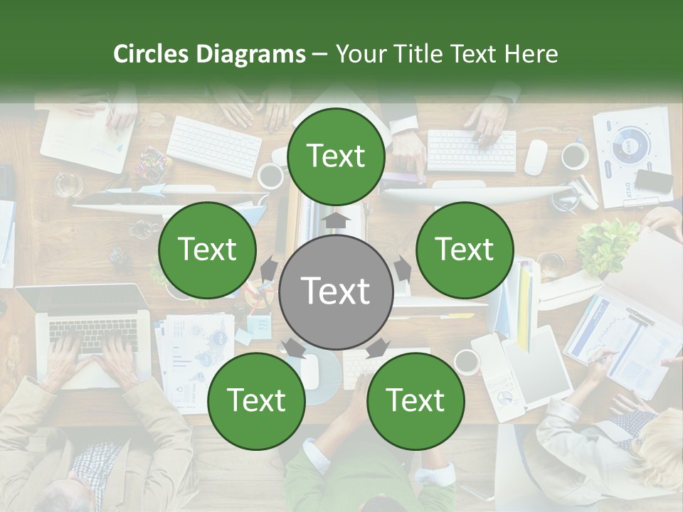 A Group Of People Sitting At A Table Working On Laptops PowerPoint Template