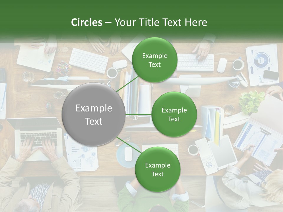 A Group Of People Sitting At A Table Working On Laptops PowerPoint Template