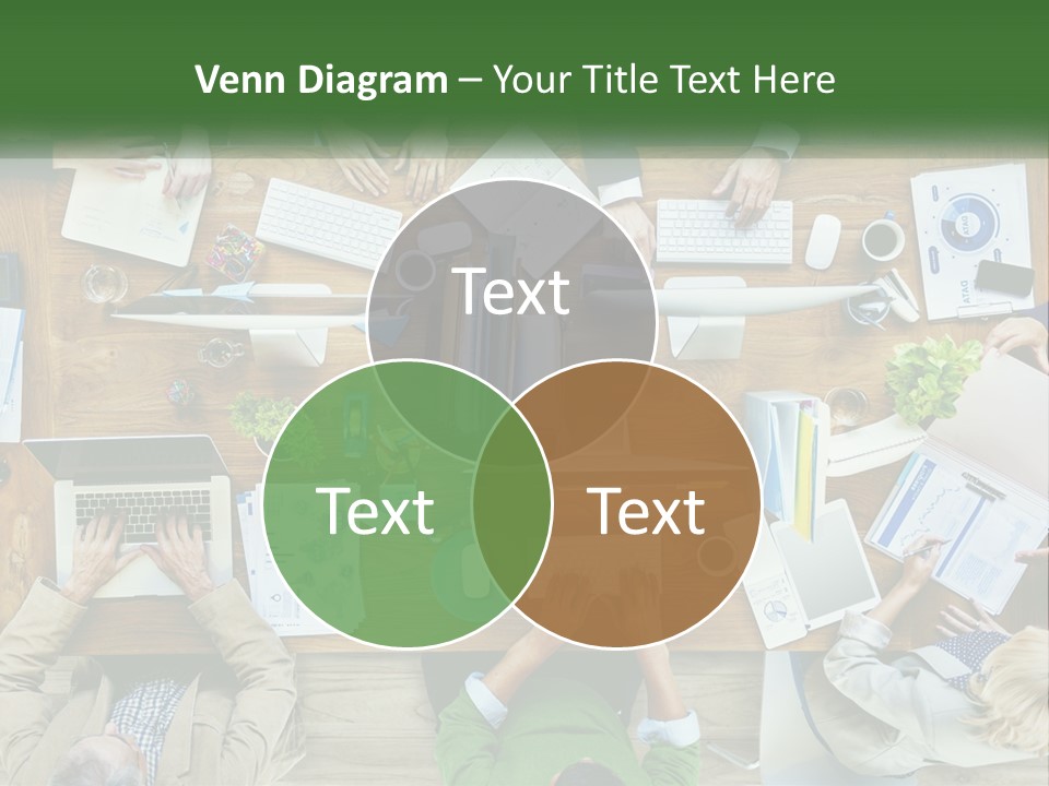 A Group Of People Sitting At A Table Working On Laptops PowerPoint Template