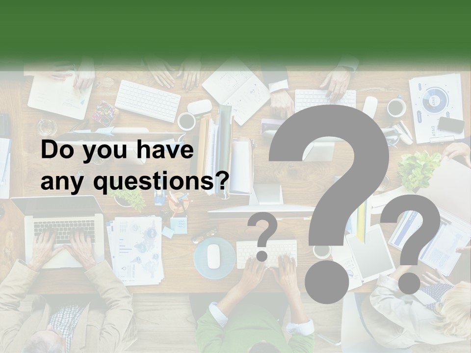 A Group Of People Sitting At A Table Working On Laptops PowerPoint Template