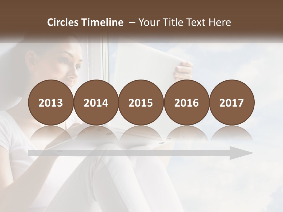 A Woman Sitting On A Window Sill Using A Laptop Computer PowerPoint Template