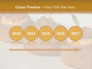 A White Plate Topped With Mini Cakes Covered In Toppings PowerPoint Template