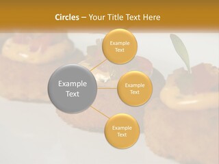 A White Plate Topped With Mini Cakes Covered In Toppings PowerPoint Template