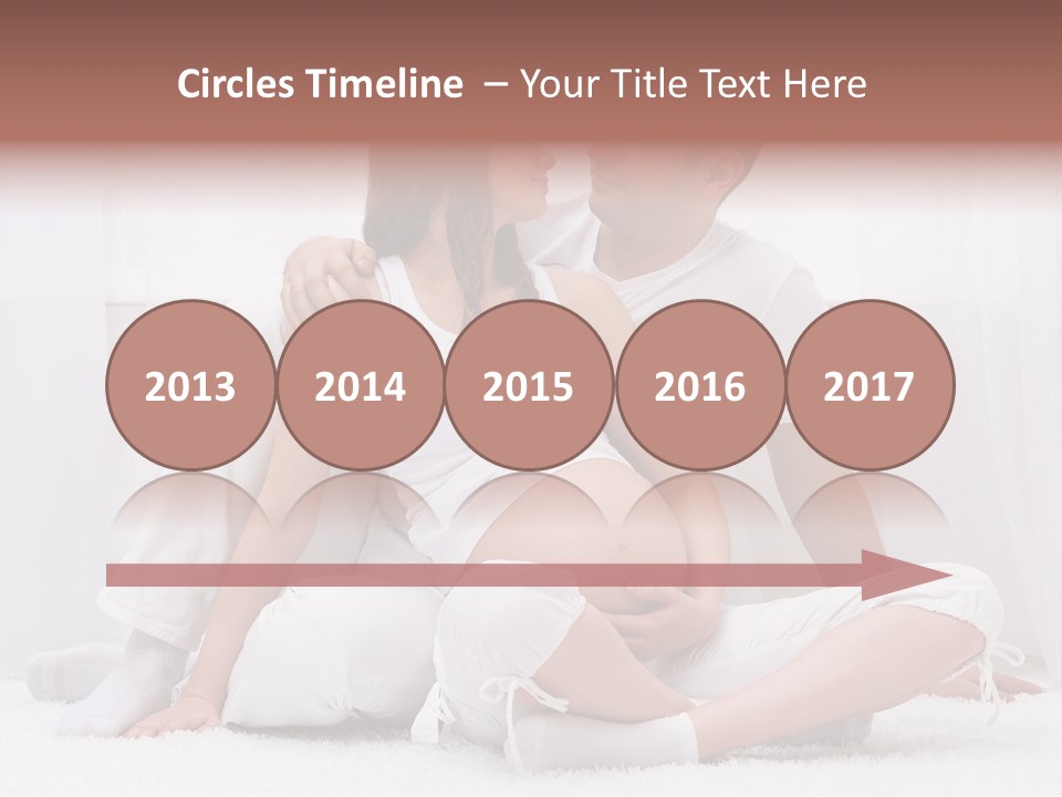 A Pregnant Couple Sitting On A Bed Together PowerPoint Template