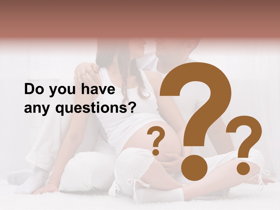 A Pregnant Couple Sitting On A Bed Together PowerPoint Template