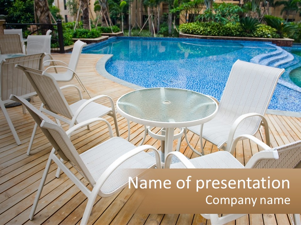 A Table And Chairs Near A Swimming Pool PowerPoint Template