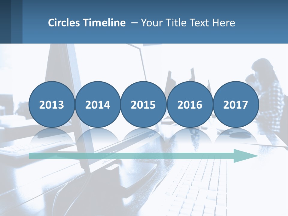 A Man Sitting In Front Of A Computer Monitor PowerPoint Template