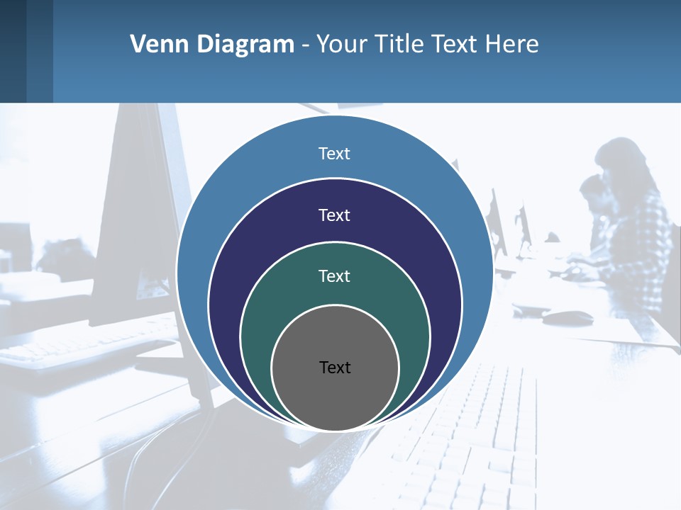 A Man Sitting In Front Of A Computer Monitor PowerPoint Template