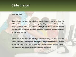 A Group Of People Sitting At A Computer Desk PowerPoint Template