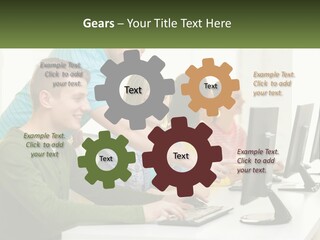 A Group Of People Sitting At A Computer Desk PowerPoint Template