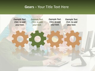 A Group Of People Sitting At A Computer Desk PowerPoint Template