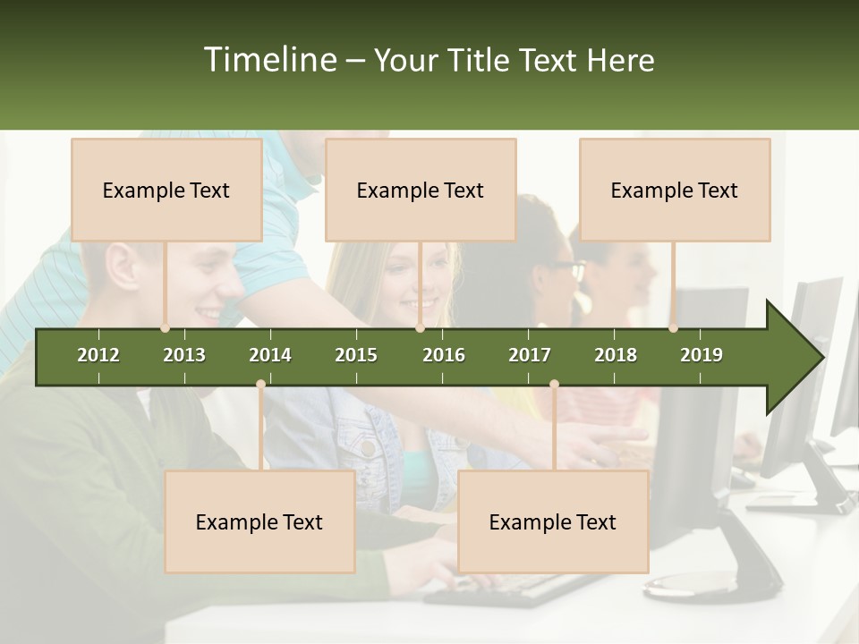 A Group Of People Sitting At A Computer Desk PowerPoint Template