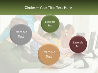 A Group Of People Sitting At A Computer Desk PowerPoint Template