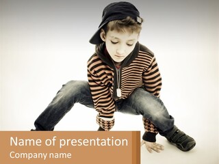 A Young Boy Sitting On The Ground With A Hat On PowerPoint Template