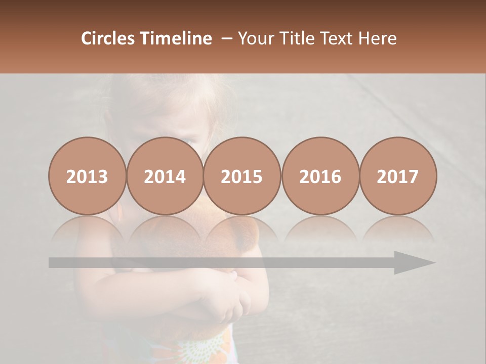 A Little Girl Holding A Teddy Bear In Her Arms PowerPoint Template