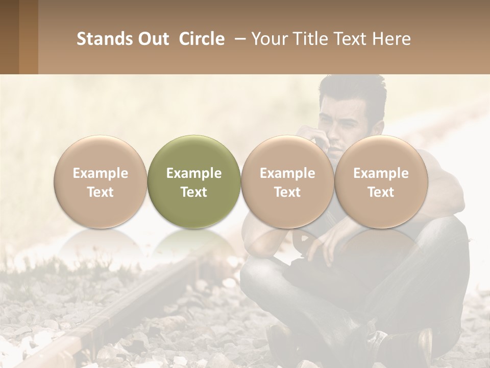 A Man Sitting On A Train Track Talking On A Cell Phone PowerPoint Template