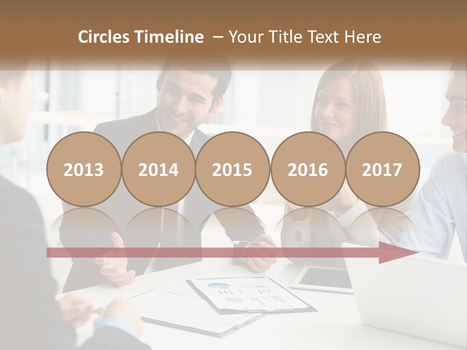 A Group Of People Sitting Around A Table Talking PowerPoint Template