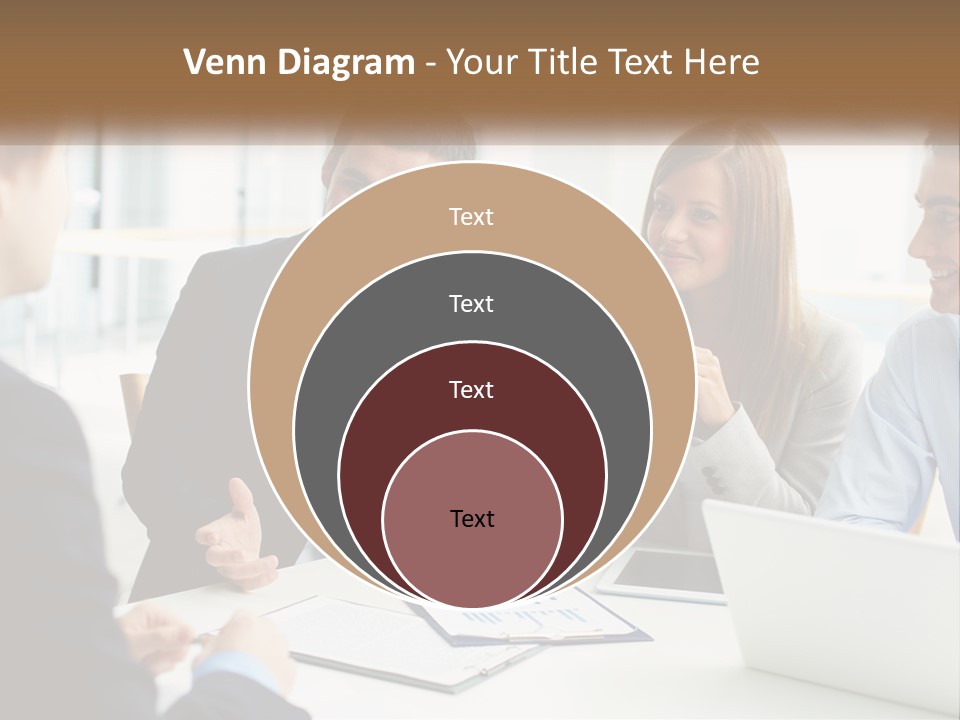A Group Of People Sitting Around A Table Talking PowerPoint Template