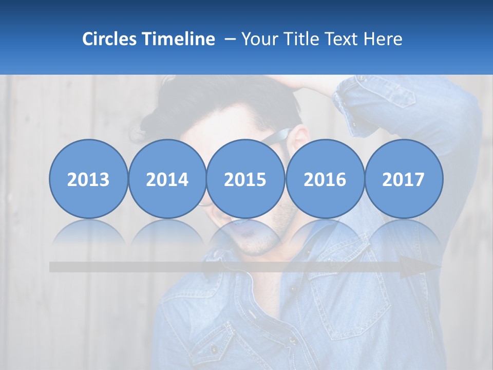 A Man Wearing Glasses And A Denim Shirt PowerPoint Template