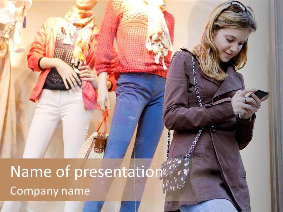 A Woman Looking At Her Cell Phone In Front Of Mannequins PowerPoint Template