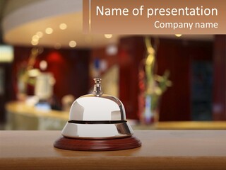 A Bell Sitting On Top Of A Wooden Table PowerPoint Template