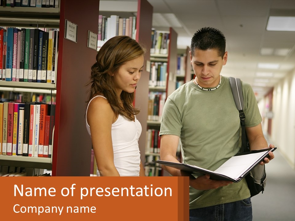A Man And A Woman Looking At A Book In A Library PowerPoint Template