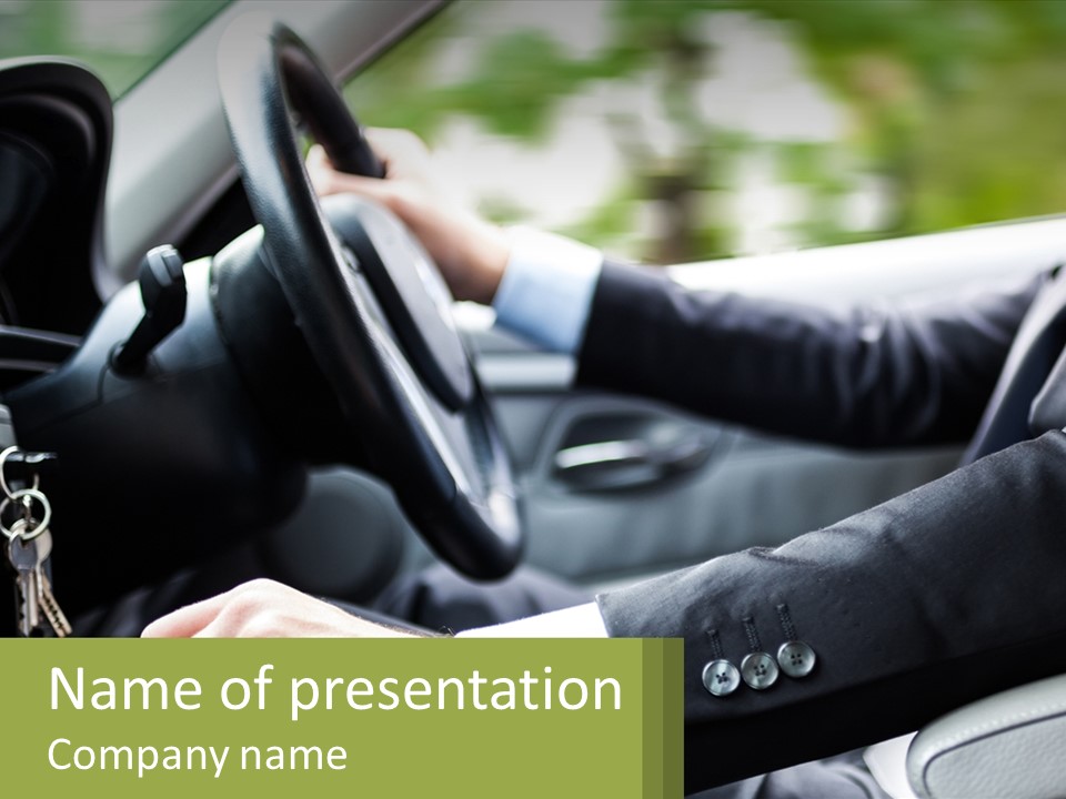 A Man Driving A Car With A Key Chain In His Hand PowerPoint Template