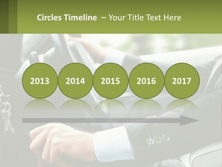 A Man Driving A Car With A Key Chain In His Hand PowerPoint Template