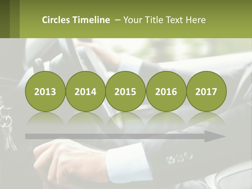 A Man Driving A Car With A Key Chain In His Hand PowerPoint Template