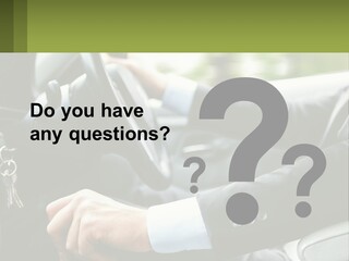 A Man Driving A Car With A Key Chain In His Hand PowerPoint Template