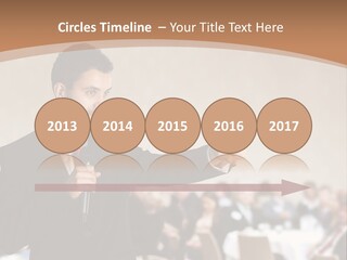 A Man In A Suit Is Giving A Presentation PowerPoint Template