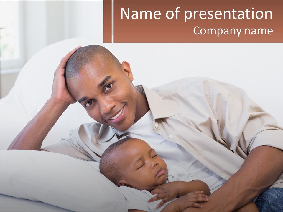 A Man Laying On A Couch Holding A Baby PowerPoint Template