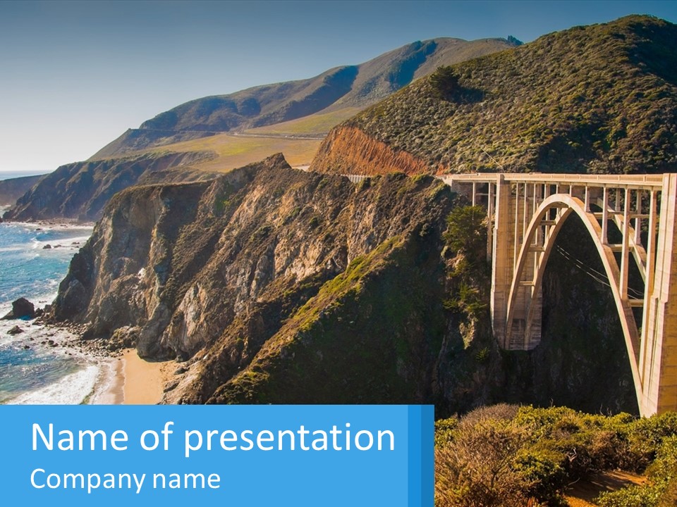 A Bridge Over A Body Of Water With Mountains In The Background PowerPoint Template