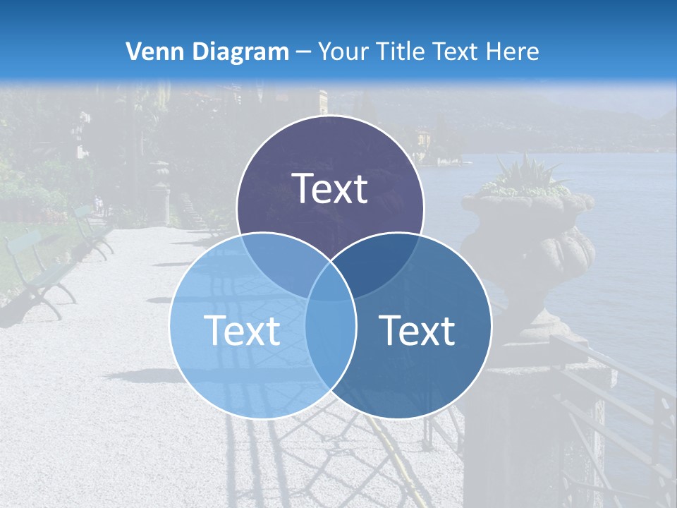 A Stone Walkway Next To A Body Of Water With Mountains In The Background PowerPoint Template