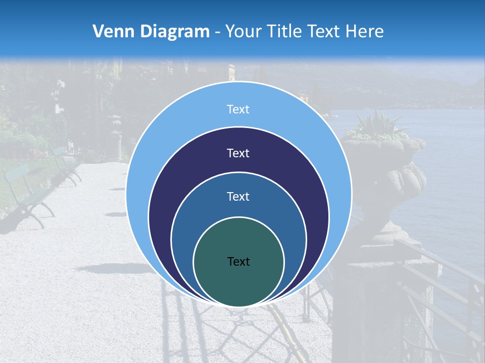 A Stone Walkway Next To A Body Of Water With Mountains In The Background PowerPoint Template