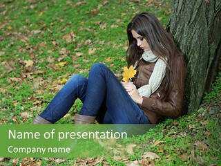 A Woman Sitting Under A Tree Holding A Leaf PowerPoint Template