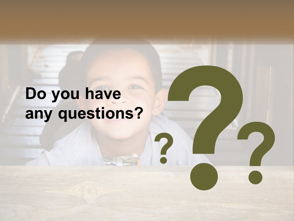 A Young Boy Is Smiling For The Camera PowerPoint Template