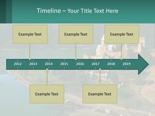 A Large Castle Sitting On Top Of A Lush Green Hillside PowerPoint Template