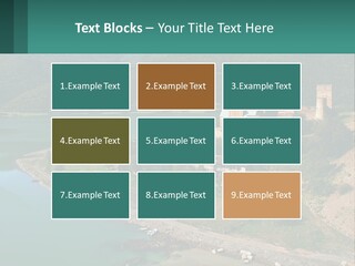 A Large Castle Sitting On Top Of A Lush Green Hillside PowerPoint Template