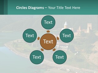 A Large Castle Sitting On Top Of A Lush Green Hillside PowerPoint Template