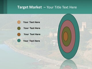 A Large Castle Sitting On Top Of A Lush Green Hillside PowerPoint Template