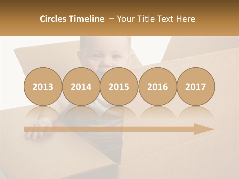 A Baby Sitting In A Cardboard Box With A Smile On His Face PowerPoint Template